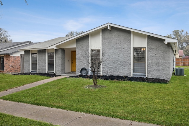 view of front facade with a front yard and central AC unit