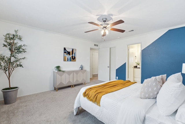 bedroom with ensuite bath, ornamental molding, ceiling fan, and carpet