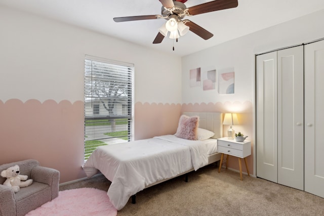 bedroom featuring light carpet, a closet, and ceiling fan