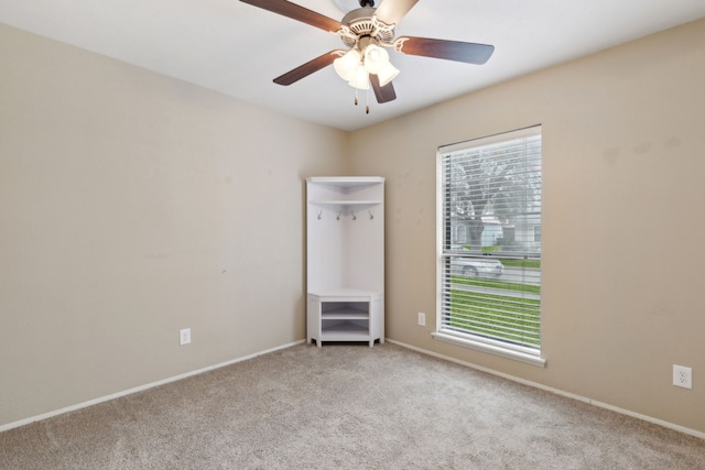 unfurnished room featuring carpet, ceiling fan, and baseboards