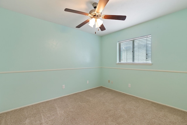 empty room featuring ceiling fan and carpet