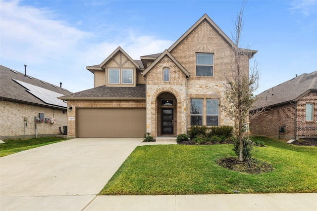 view of front of property with a garage and a front lawn