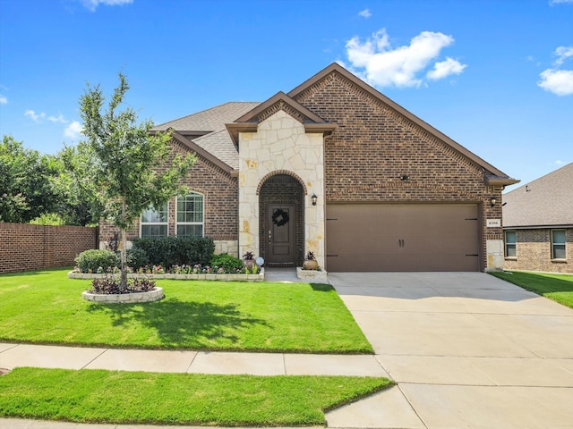 view of front of property with driveway, a front lawn, stone siding, a garage, and brick siding