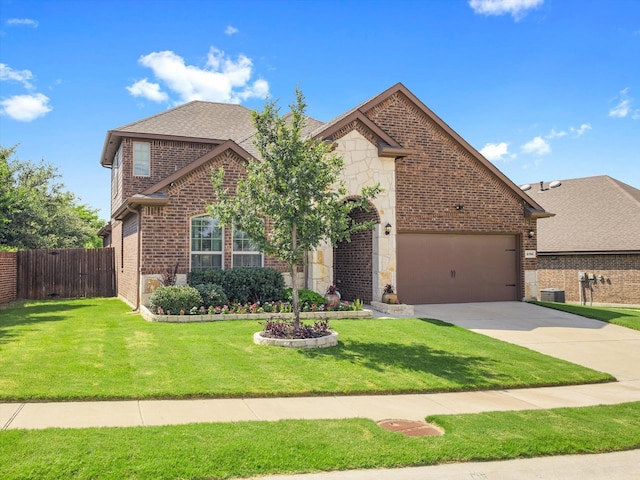 2705 Colorado Dr, Little Elm, TX 75068 - view of front facade featuring concrete driveway, brick siding, an attached garage, stone siding, and roof with shingles