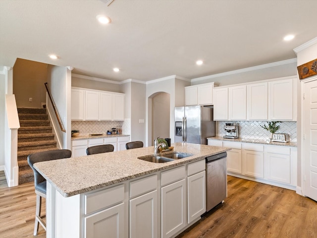 2705 Colorado Dr, Little Elm, TX 75068 - kitchen with appliances with stainless steel finishes, a sink, an island with sink, recessed lighting, and backsplash