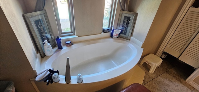 bathroom featuring tile patterned floors and a tub to relax in