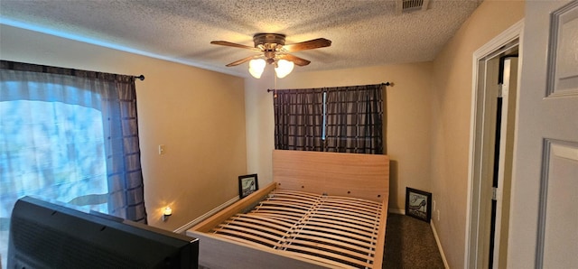 interior space featuring ceiling fan and a textured ceiling