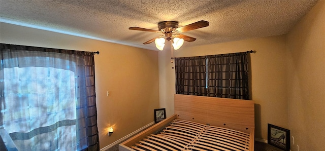 interior space featuring ceiling fan and a textured ceiling