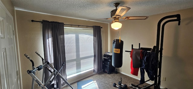 workout room with ceiling fan, carpet flooring, and a textured ceiling