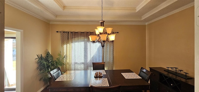 dining room with crown molding, a notable chandelier, and a tray ceiling