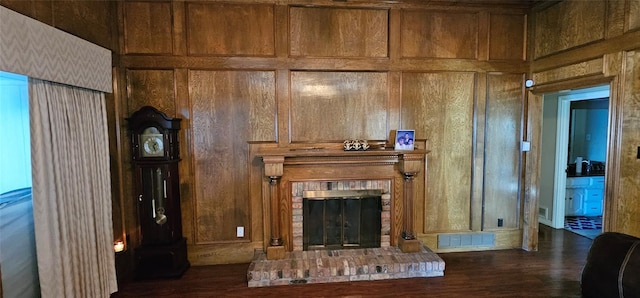 unfurnished living room with dark hardwood / wood-style flooring, wooden walls, and a fireplace