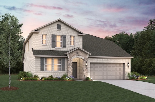 view of front of home with a garage and a yard