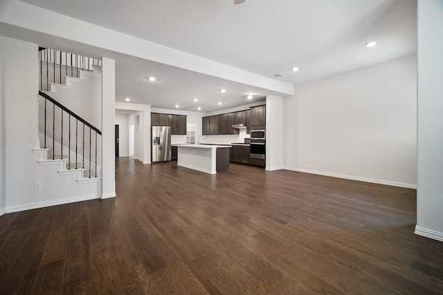 3244 Cross Shore Dr, Anna, TX 75409 - unfurnished living room featuring stairs, baseboards, recessed lighting, and dark wood-style flooring
