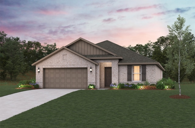 view of front of home featuring a garage and a lawn