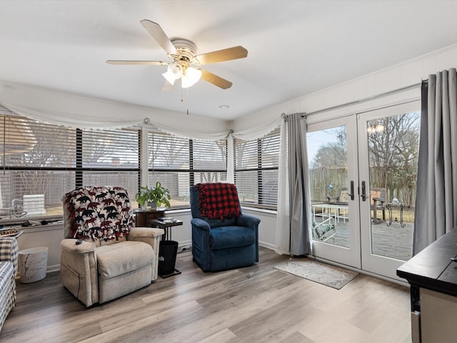 interior space with ceiling fan and french doors