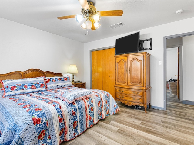 bedroom with ceiling fan and light hardwood / wood-style flooring