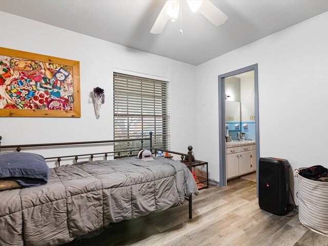 bedroom with ceiling fan, connected bathroom, and light hardwood / wood-style floors