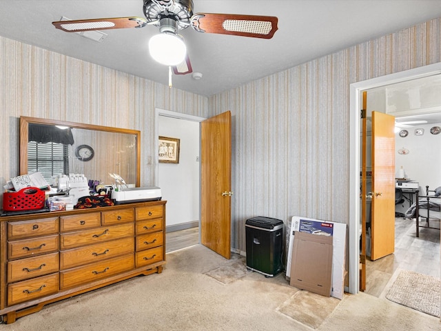 bedroom with ceiling fan and light carpet