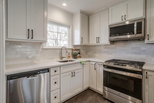 kitchen with tasteful backsplash, stainless steel appliances, sink, and white cabinets