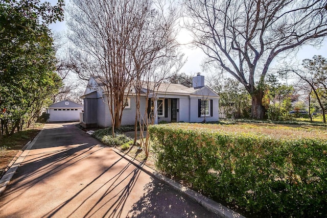 ranch-style home featuring an outbuilding and a garage