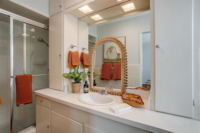 bathroom with vanity and a shower with shower door