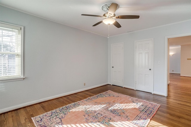 bedroom featuring wood-type flooring, ceiling fan, and crown molding