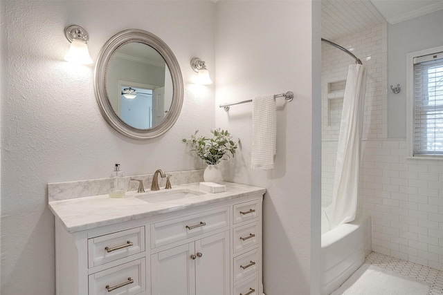 bathroom featuring ornamental molding, shower / bathtub combination with curtain, and vanity