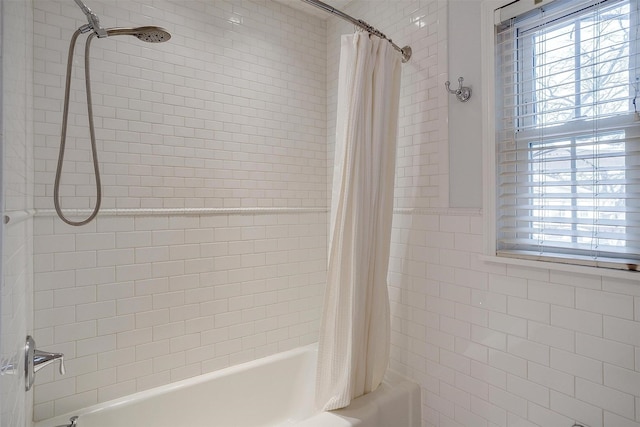 bathroom with a healthy amount of sunlight and shower / bath combination with curtain