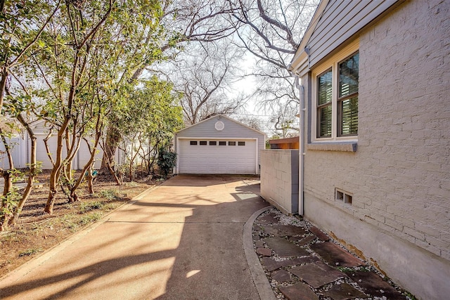 view of side of property featuring a garage and an outdoor structure