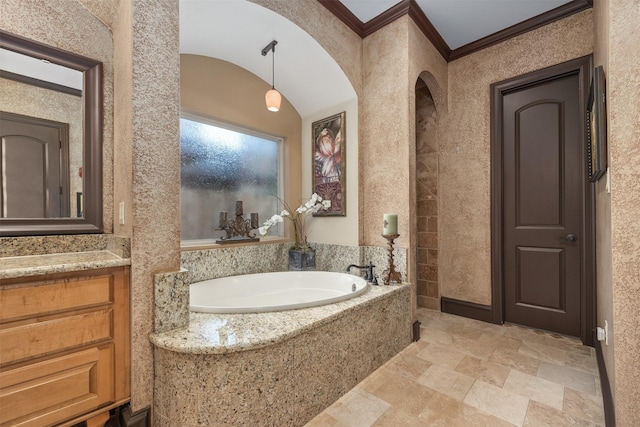 bathroom with ornamental molding, vanity, and tiled tub