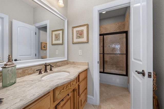 bathroom with vanity, a shower with shower door, and tile patterned flooring