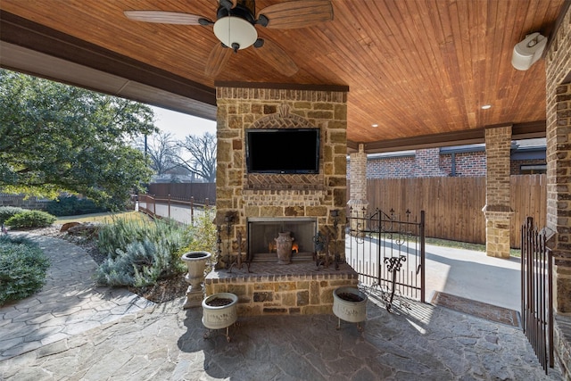 view of patio / terrace featuring an outdoor stone fireplace