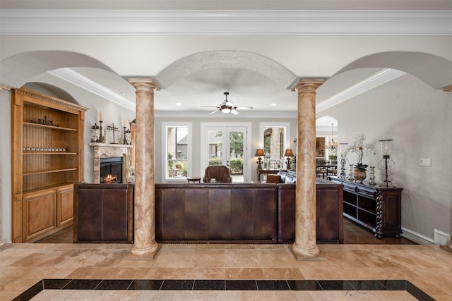 living room featuring ceiling fan, ornamental molding, and ornate columns