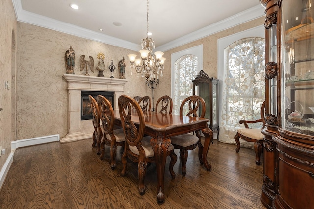 dining space featuring an inviting chandelier, crown molding, dark wood-type flooring, and a high end fireplace