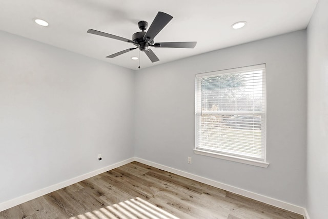 spare room featuring ceiling fan and light wood-type flooring