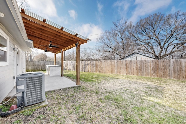 view of yard with cooling unit, ceiling fan, and a patio area