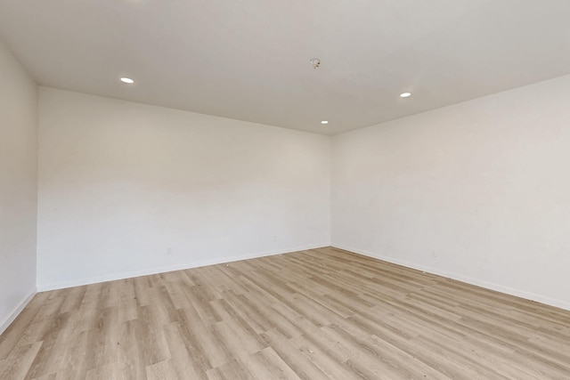 unfurnished room with light wood-type flooring