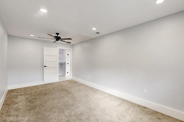 carpeted spare room with ceiling fan