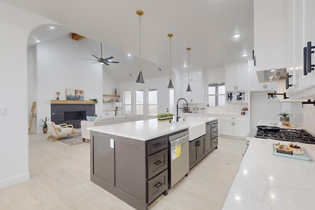 kitchen featuring stainless steel appliances, decorative light fixtures, sink, and white cabinets