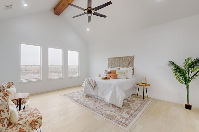 bedroom with ceiling fan, high vaulted ceiling, beam ceiling, and light hardwood / wood-style flooring