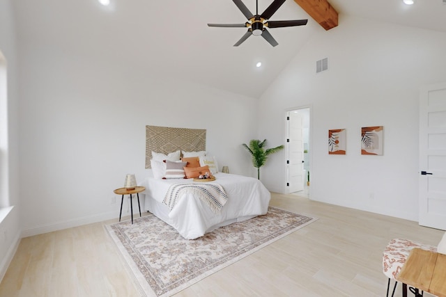 bedroom featuring beam ceiling, light hardwood / wood-style flooring, high vaulted ceiling, and ceiling fan