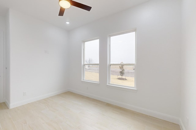 unfurnished room with ceiling fan and light hardwood / wood-style floors