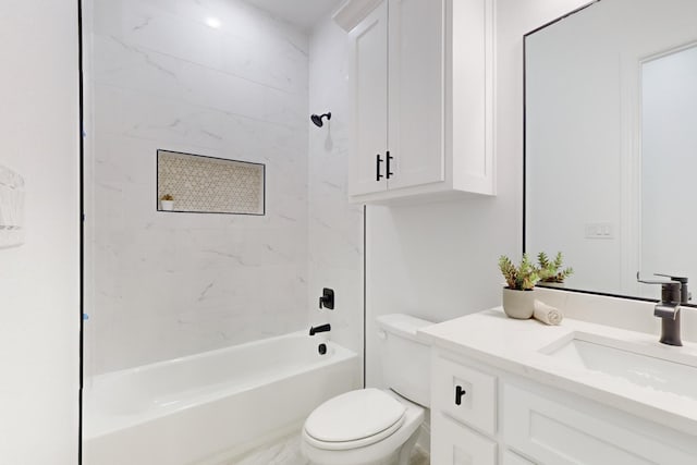 full bathroom featuring tiled shower / bath, vanity, and toilet