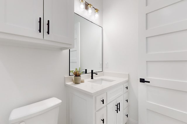 bathroom featuring vanity and toilet