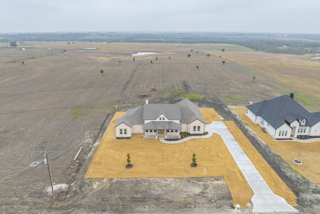 birds eye view of property with a rural view