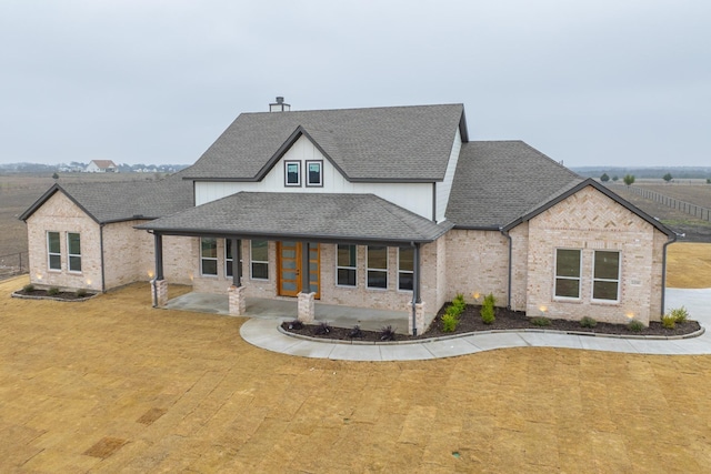 view of front of home featuring covered porch and a front yard