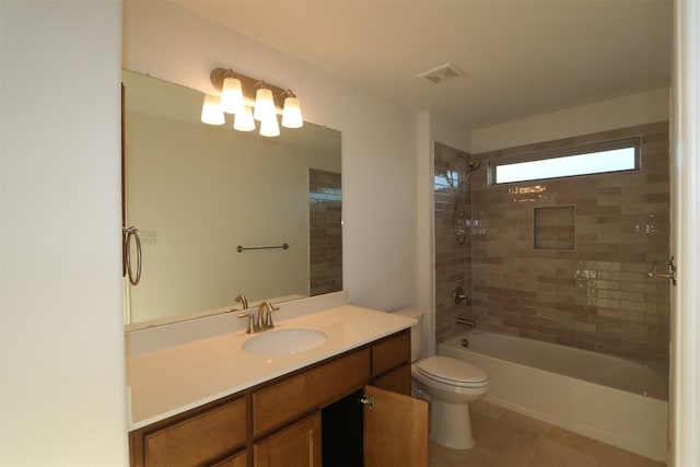 full bathroom featuring tiled shower / bath combo, vanity, tile patterned flooring, and toilet