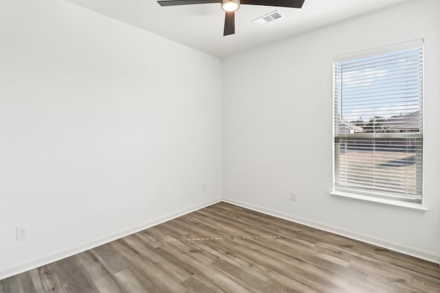 empty room featuring hardwood / wood-style flooring and ceiling fan