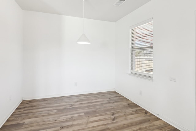 empty room with hardwood / wood-style floors