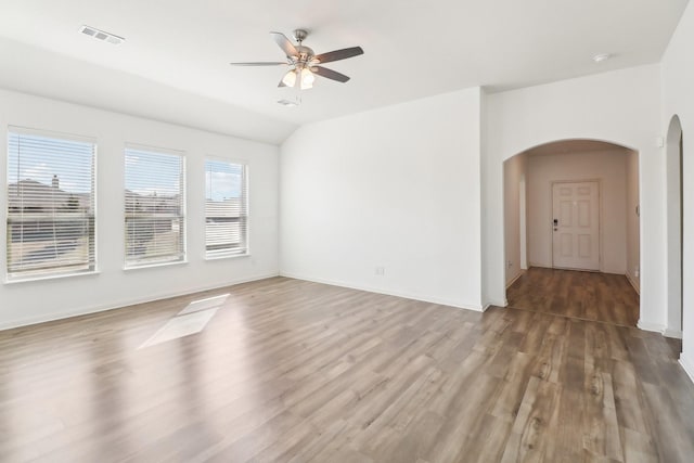 spare room with vaulted ceiling, ceiling fan, and hardwood / wood-style floors